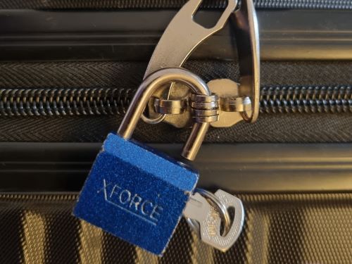 A padlock can be used as an extra travel safety gadget for solo travelers
